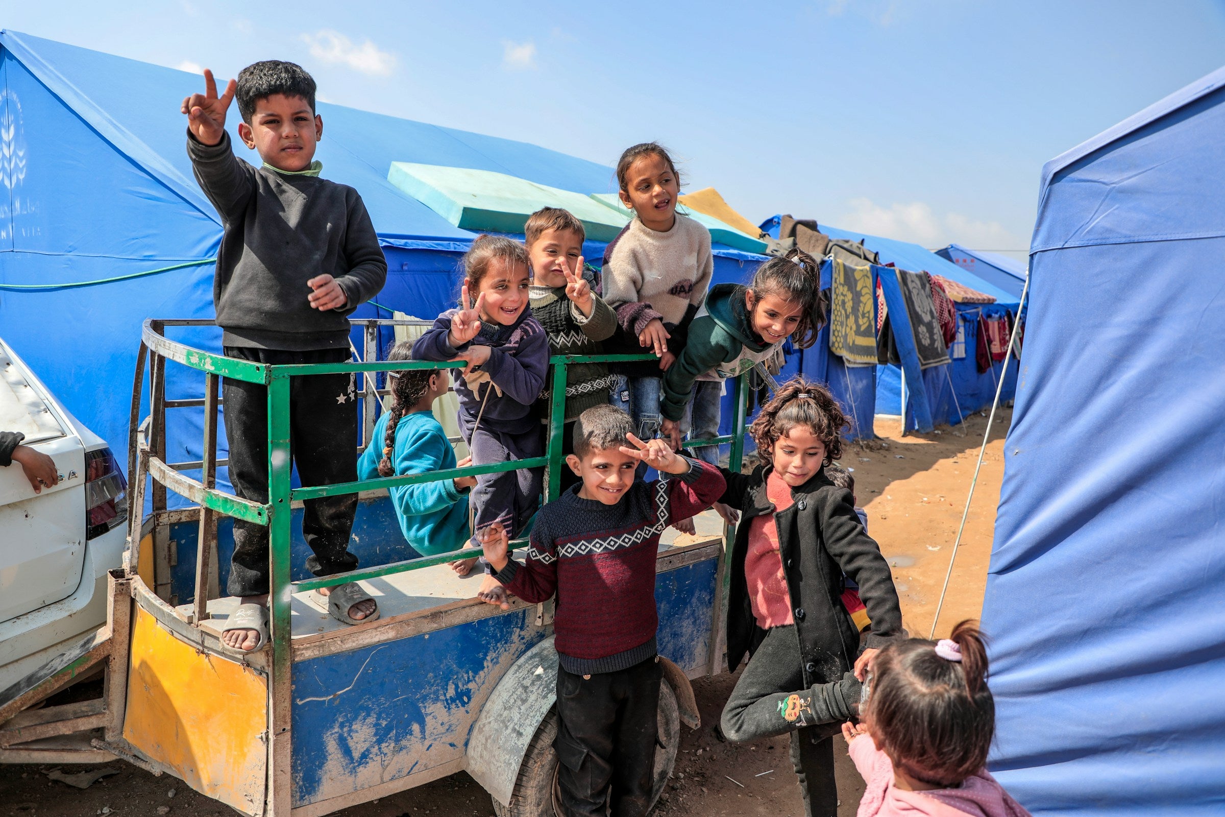 Gaza - Palestine Children smile despite the suffering they experience every minute from the heat, lack of water, tents and diseases in a camp for displaced people in the northern Gaza Strip